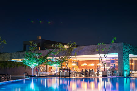 restaurant with swimming pool during night time thumbnail