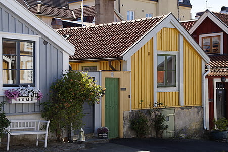 yellow and white house at daytime thumbnail