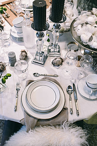 Fancy restaurant dinner table decorated with quail eggs and feathers thumbnail