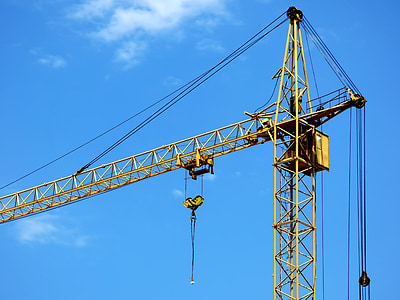 close-up photography of yellow tower crane during daytime thumbnail