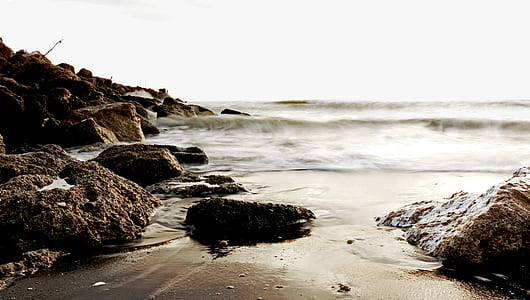 time-lapse photo of waves crashing on rocks thumbnail