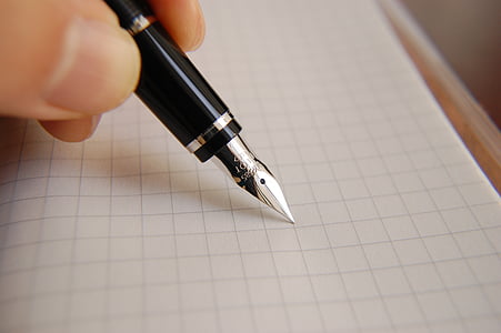 person holding black and grey fountain pen thumbnail