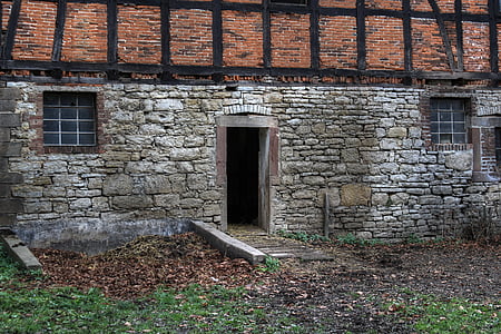 gray and brown concrete house with door open thumbnail