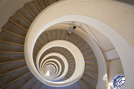 boy going down a spiral concrete staircase thumbnail