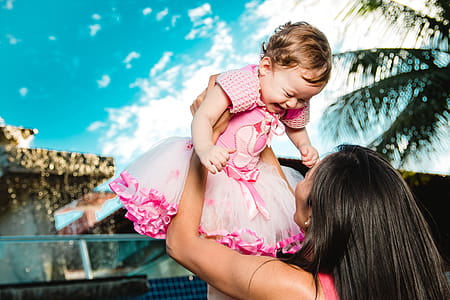 Woman Holding Baby Above Head thumbnail