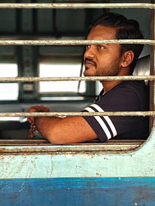 Man Wearing Black and White T-shirt Inside a Vehicle thumbnail