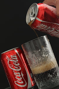 person pouring Coca-Cola soda on highball glass thumbnail