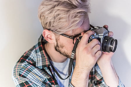 man holding land camera thumbnail