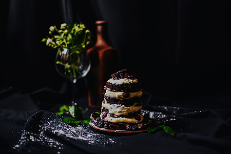 selective focus of cookies and creams cake in ceramic saucer near flower thumbnail