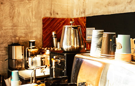 Stainless Steel Coffee Pot and Disposable Cups on Top of Counter thumbnail