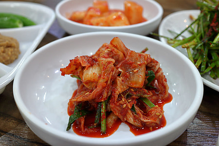 kimchi in saucer on table thumbnail