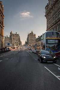 black Citroen car parked beside bus on street thumbnail