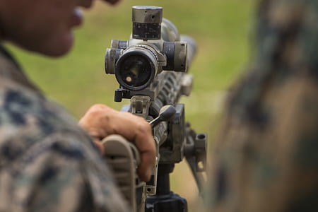 man holding sniper rifle thumbnail