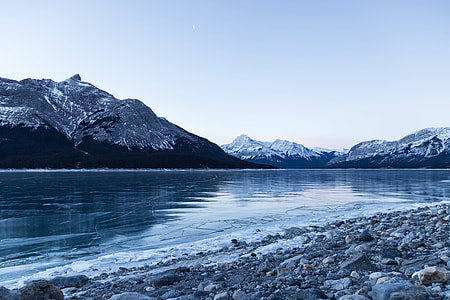 body of water surrounded with mountains thumbnail