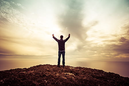 silhouette of man standing on hill thumbnail