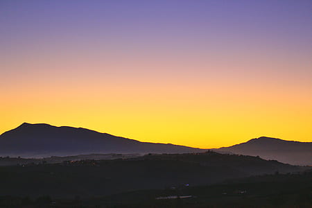 silhouette photo of mountain during golden hour thumbnail