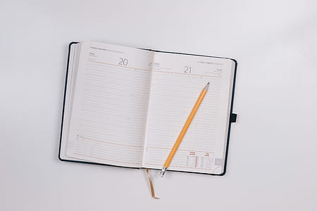 Diary on white table with a pencil thumbnail
