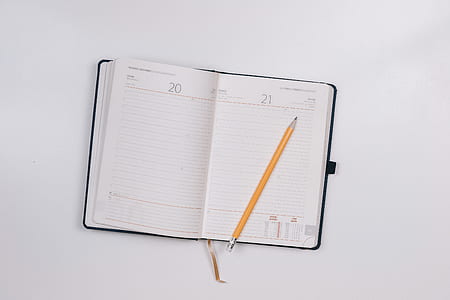 yellow pencil on white ruled book thumbnail