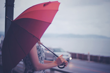Woman holding red umbrella thumbnail
