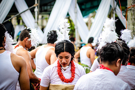 person in white collared top surrounded by people thumbnail