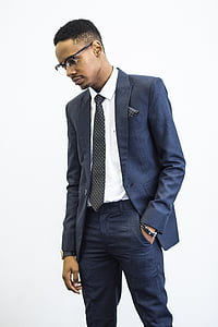 man wearing blue suit jacket and necktie looking at his right side thumbnail