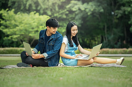 man and woman sitting on the field thumbnail
