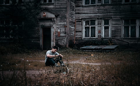 man sitting on grass field thumbnail