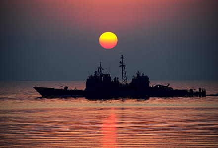 boat against sun silhouette photo thumbnail