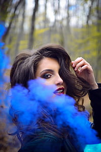 Close-Up Photography of a Woman Near Blue Smoke thumbnail