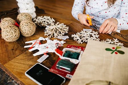 woman cutting a Christmas decors thumbnail