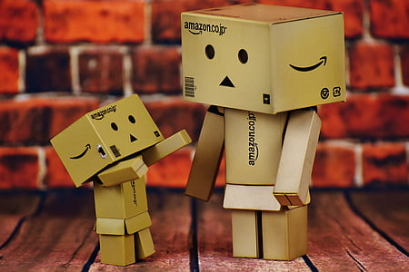 two Amazon box figure on brown wooden board thumbnail