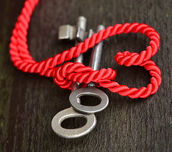 selective focus photography of two keys in rope thumbnail