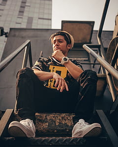 man sitting on metal stair thumbnail