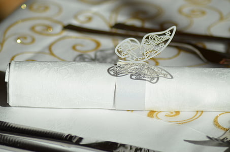 white rolled invitation card on table thumbnail