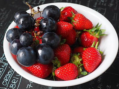 strawberries with grapes in white ceramic bowl thumbnail