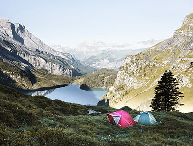two dome tents on grass mountain thumbnail
