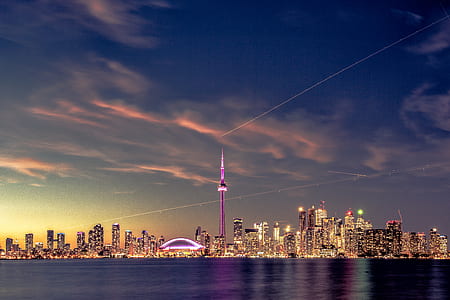 skyscrapers near body of water during twilight thumbnail