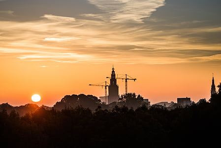 silhouette photo of building during sunrise thumbnail