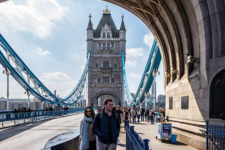 Man and Woman Standing Near Brown Concrete Building thumbnail