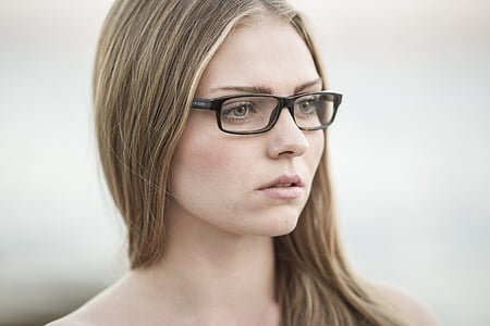 woman wearing clear eyeglasses with black frames thumbnail