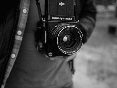person holding black DSLR camera thumbnail
