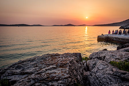 people at seashore during sunset thumbnail
