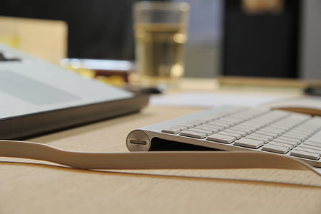 silver keyboard on brown table thumbnail