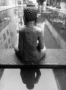 gray scale photography of Gautama Buddha sitting in front pond thumbnail