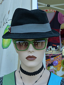 female mannequin wearing gray and black hat and green framed sunglasses thumbnail