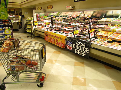 gray shopping cart in front of display freezer thumbnail