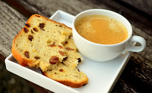 sliced bread and cup of coffee on white ceramic plate thumbnail