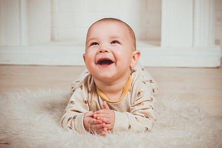 baby in white crew-neck sweater inside room thumbnail