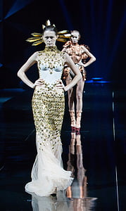 woman wearing white and gold-colored sleeveless floor-length dress thumbnail