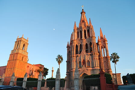 brown concrete cathedral beside brown building thumbnail